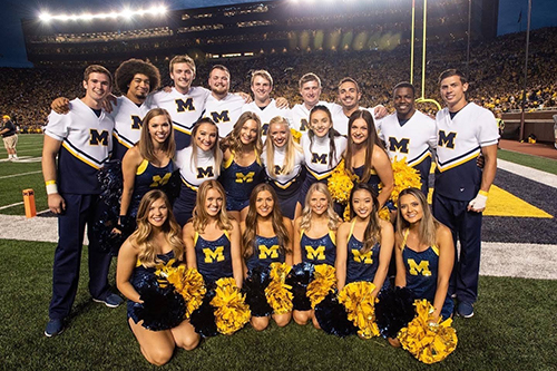 group photo of Michigan cheer squad in the Big House