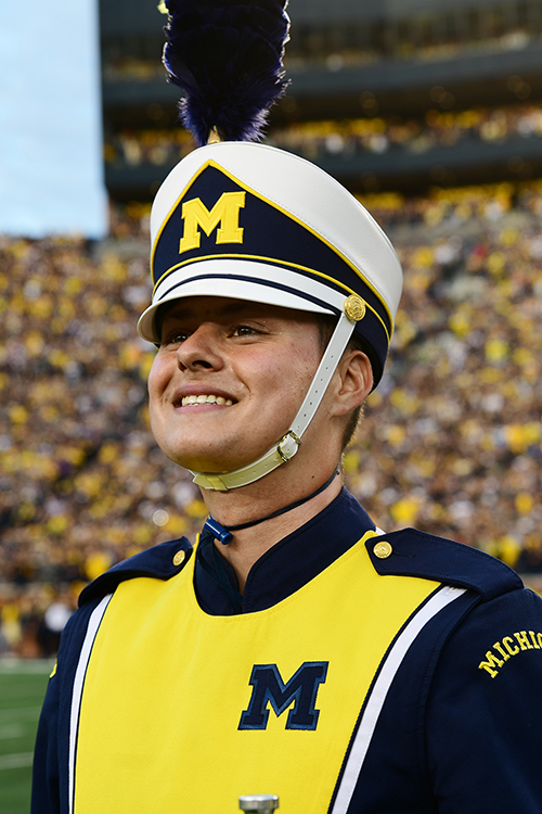 Connor in Michigan Marching Band uniform on the field of the Big House during gameday